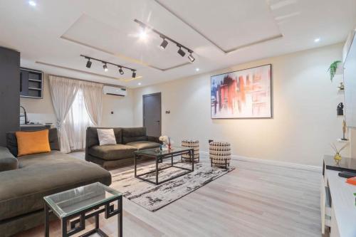 a living room with a couch and a table at Auresta haven in Lekki