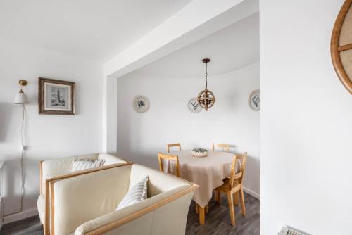 a white dining room with a table and chairs at 5 South Street in Arbroath