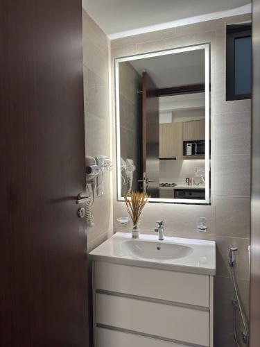 a bathroom with a sink and a mirror at Skyline Heights Colombo in Colombo
