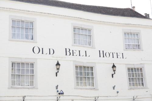 an old bell hotel written on the side of a white building at The Old Bell - Warminster in Warminster