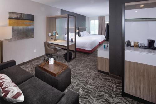 a hotel room with a couch and a bed at Springhill Suites By Marriott Newark Downtown in Newark