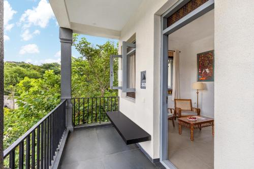 a balcony with a table and a chair at Sterling Hibis Vellore in Vellore