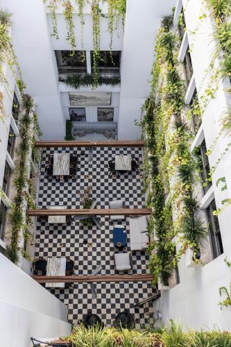 an internal courtyard of a building with plants at Hotel 1935- By Adam Hotels in Tel Aviv
