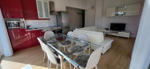 a kitchen and living room with a glass table and chairs at Apartment Bergblick by Alpenidyll Apartments in Weißenbach