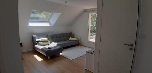 a living room with a couch and a window at Au calme en pays d'Oust et de Brocéliande in Montertelot