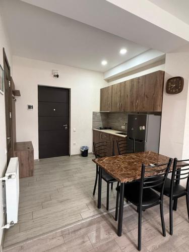 a kitchen and dining room with a table and chairs at Bakuriani, Trialeti Residence in Bakuriani