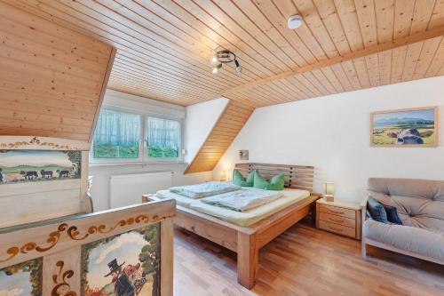 a bedroom with a bed and a couch at Ruhbauernhof in Kirchzarten