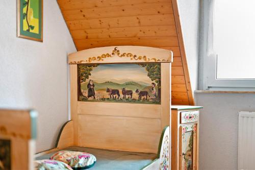 a toy house with a painting on the wall at Ruhbauernhof in Kirchzarten
