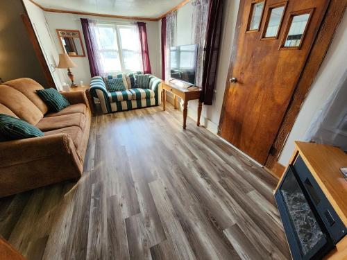 a living room with a couch and a wooden floor at Country Living in West Monroe