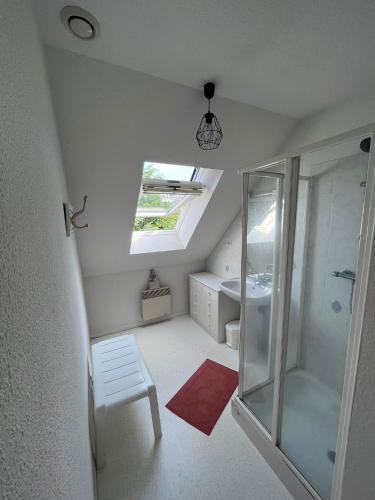 a bathroom with a shower and a bench and a sink at Maison de vacances accès direct plage residence sécurisée in Jullouville-les-Pins
