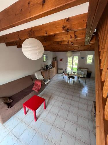 a living room with a couch and a table at Maison de vacances accès direct plage residence sécurisée in Jullouville-les-Pins