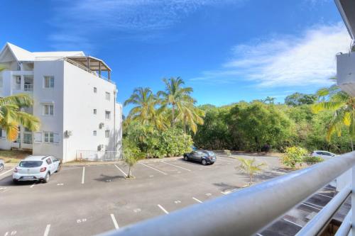 a view from a balcony of a parking lot at Apt Le Sunny - T4 Boucan Canot in Saint-Paul