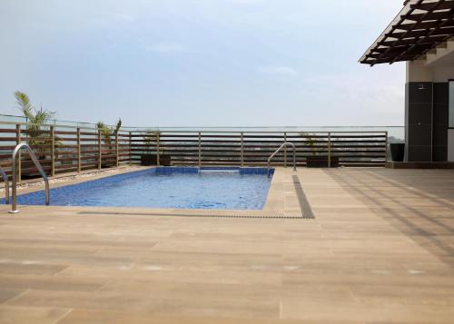 a swimming pool on the side of a building at Akwaaba Retreats in Tema