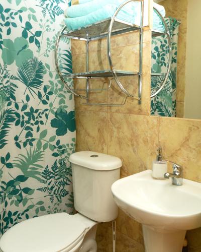 a bathroom with a toilet and a sink at El jardín secreto Pisco Elqui in Pisco Elqui