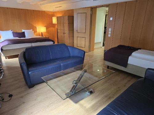 a living room with a couch and a bed at Olympia Hotel Zurich in Zürich