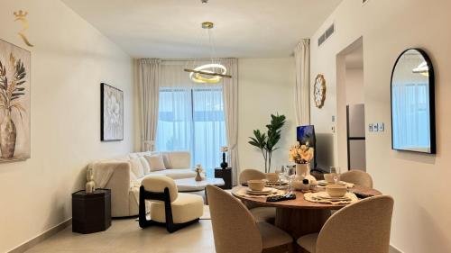 a living room with a table and chairs and a couch at Yas Island 4BR -Luxury Grand Retreat in Abu Dhabi