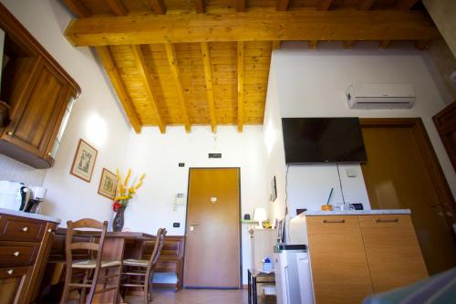 a kitchen with wooden ceilings and a kitchen with a table at Fiordaliso in Montichiari