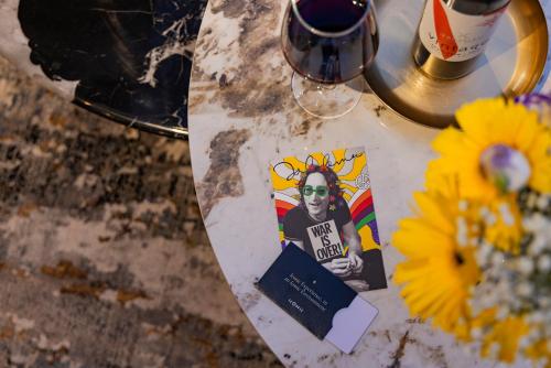 a table with a table cloth with a book and flowers at Iconic Hotel in Tel Aviv
