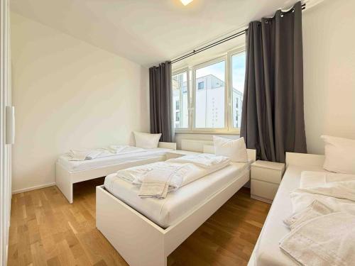 two beds in a room with a window at AM1237 moderne Monteurwohnung mit Balkon in Amberg
