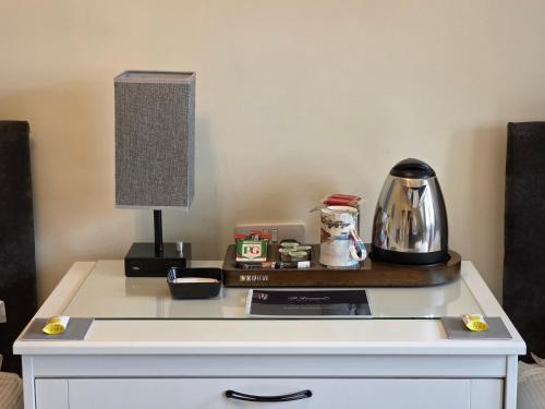 a table with a lamp on top of it at St Leonards Guest House in Largs