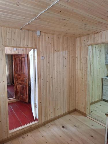 a room in a house with wood paneling at საოჯახო სასტუმრო,,ოდა ხიხანთან'' 
