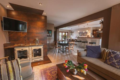 a living room with a couch and a fireplace at Masia Boutique con Infinity Pool in Calvinyá
