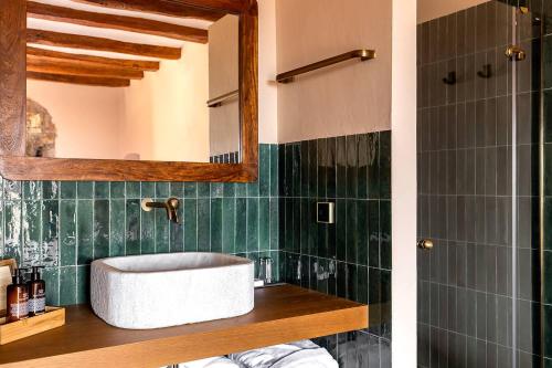 a bathroom with a sink and a mirror at Hotel Montrubí 1771 - Slow Winery Hotel - Adults only in Font-Rubí