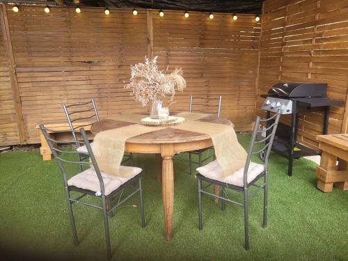 a dining room table with chairs and a piano at Love room avec jaccuzi privé in Perpignan