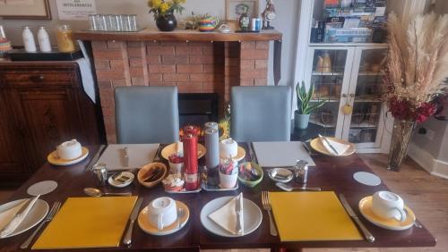 a table with plates of food on top of it at St Leonards Guest House in Largs