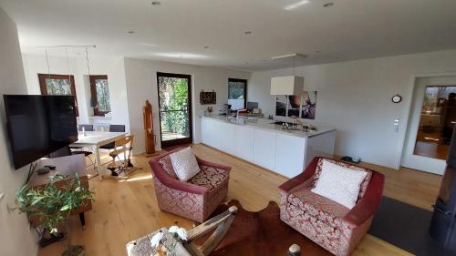 a large living room with two chairs and a table at Wolke 1 in Seebruck