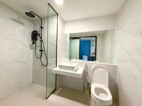 a bathroom with a toilet and a sink and a shower at Vetro 11 Premier Suites by SSVC in Kota Kinabalu