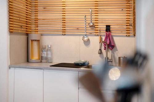 a kitchen with white cabinets and a counter top at Ruhbauernhof in Kirchzarten