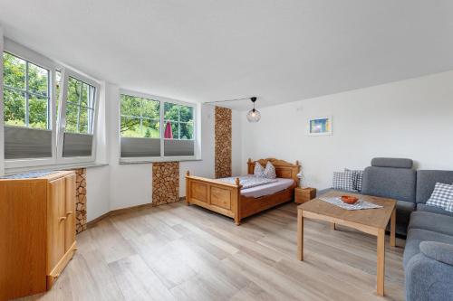 a living room with a couch and a table at Ruhbauernhof in Kirchzarten