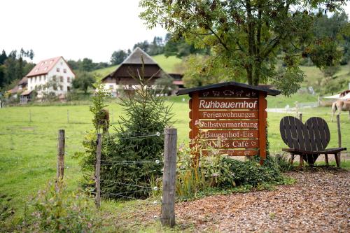 a sign with a bench next to a field at Ruhbauernhof in Kirchzarten