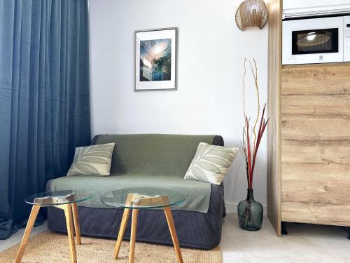 a living room with a couch and two tables at Las Dunas DM sea view in San Bartolomé de Tirajana