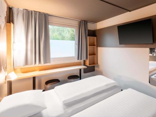 Ένα ή περισσότερα κρεβάτια σε δωμάτιο στο B&B Hotel Hannover-Nord