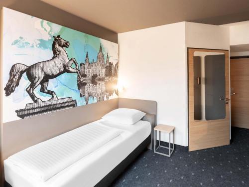 Ένα ή περισσότερα κρεβάτια σε δωμάτιο στο B&B Hotel Hannover-Nord