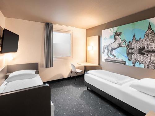 Ένα ή περισσότερα κρεβάτια σε δωμάτιο στο B&B Hotel Hannover-Nord