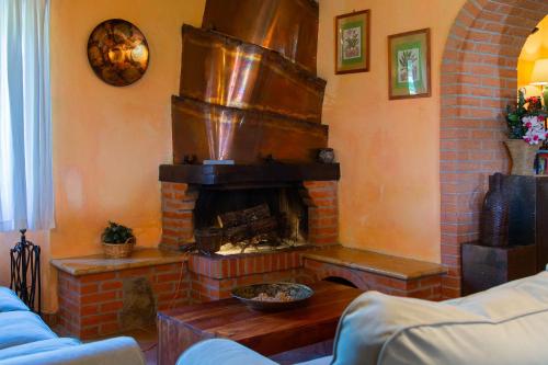a living room with a brick fireplace in a room at Casale meraviglioso Val d'Orcia con piscina in Radicofani