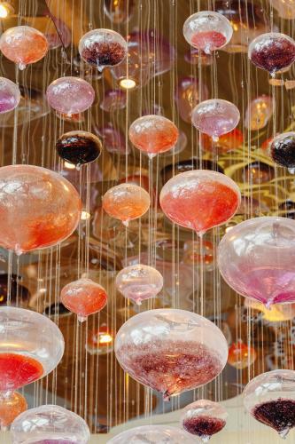 a bunch of glass balls are hanging in a display at Andaz Capital Gate Abu Dhabi, By Hyatt in Abu Dhabi