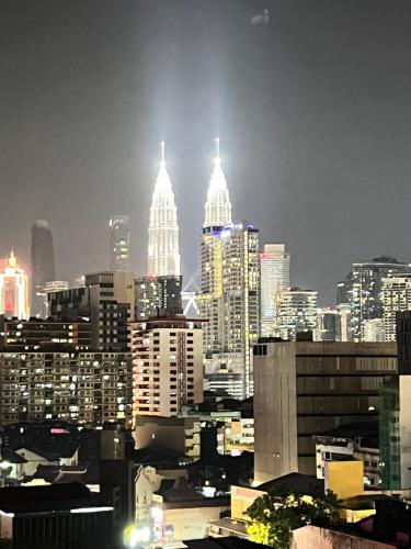 a view of a city skyline at night at Chambers by Lumira Haven Klcc in Kuala Lumpur