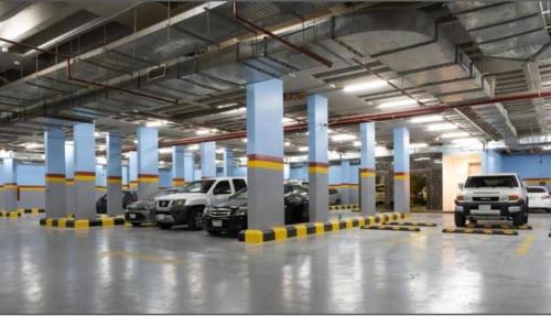 a large parking garage with cars parked in it at Tura Hotel AlNuzha- فندق ترى النزهة in Riyadh