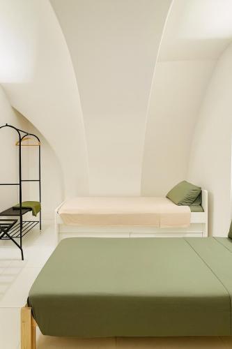 a bedroom with two beds and a chair at Casa MAR e LUNA in Amalfi