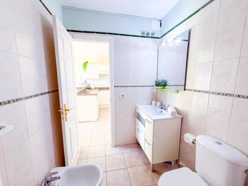 a bathroom with a toilet and a sink at Blue Ocean Oasis in Puerto de Santiago