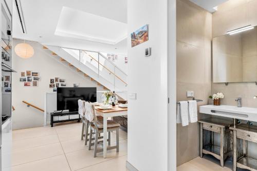a kitchen and dining room with a table and a television at MEDANO4YOU Tina's Jacuzzi Terrace Playa Chica in El Médano