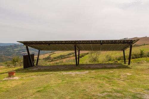 a large structure sitting on top of a hill at Casale meraviglioso Val d'Orcia con piscina in Radicofani