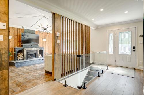 a large living room with a fireplace and a door at Spa & Lake Access - The Lakeshore in Rawdon