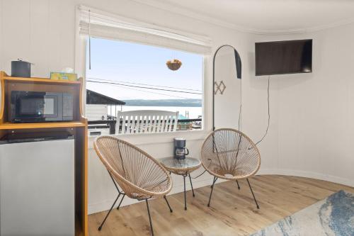 a living room with two chairs and a table and a window at Showboat Hotel in Himrod