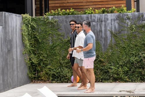 a group of three people standing on a sidewalk at Plaza San Antonio Hotel & Spa, Autograph Collection in San Antonio