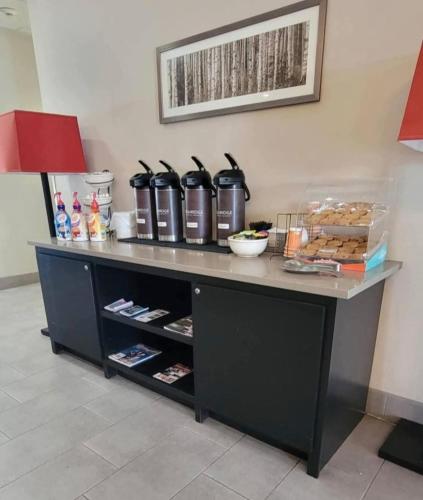 a counter with food and drinks on top of it at Country Inn & Suites by Radisson, Harlingen, TX in Harlingen
